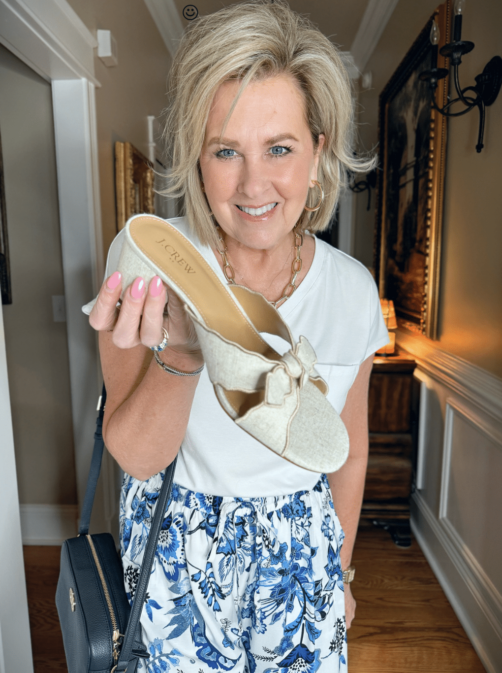 Tania Stephens is wearing a white t-shirt and bow block heels